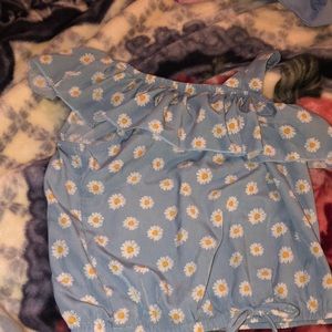 Has a little bow on front has a little flowers, a blue shirt